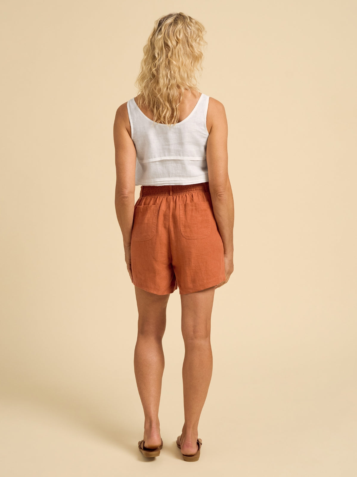 Model wears Charli Linen Shorts in Rust