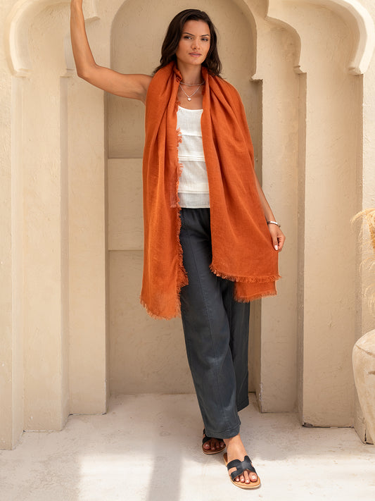 Model wears Lumi Linen Scarf in Rust
