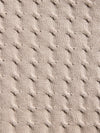 Close-up of textured beige fabric with a cable knit pattern