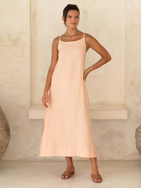 Model wears Peony Linen Dress in Coral