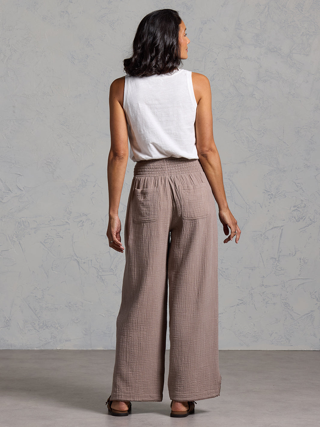A woman wearing Sur Mer Organic Cotton Pants Elm and Yarra Cotton Top Coconut from Nomad the Label