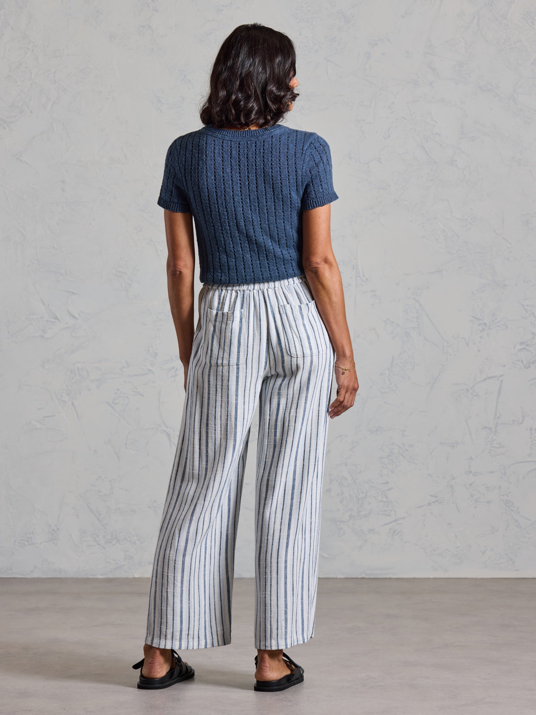 Back view of the Jolie Linen Blend Pants in coastal blue, showing back patch pockets and wide leg drape.