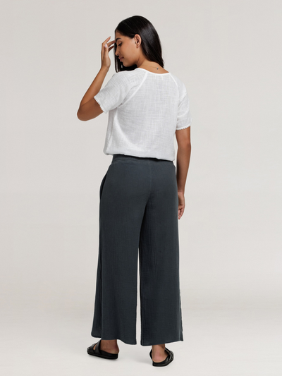 Model wears Asana Cotton Wrap Pants in Charcoal