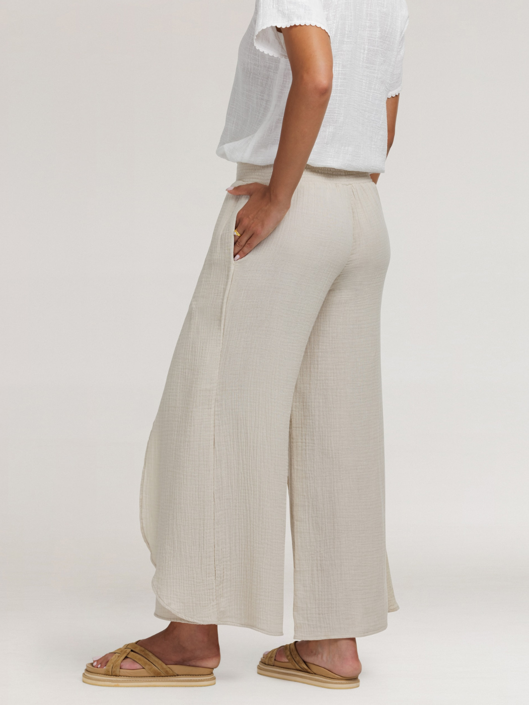 Model wears Asana Cotton Wrap Pants in Stone