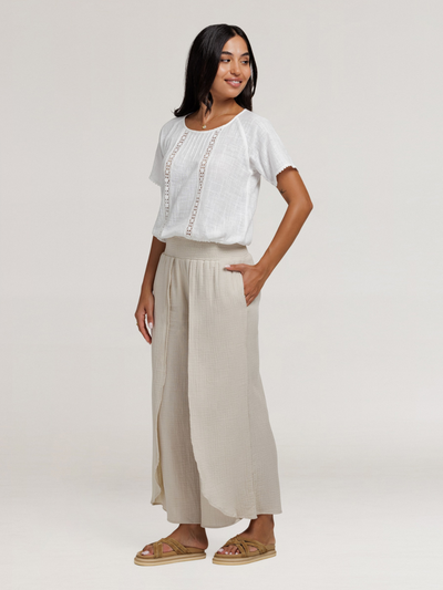 Model wears Asana Cotton Wrap Pants in Stone