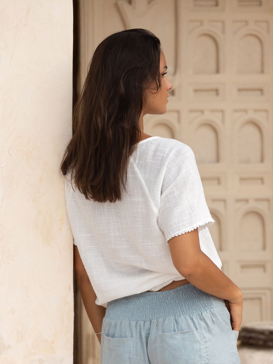 Model wears Daisy Organic Cotton Blouse in Ivory