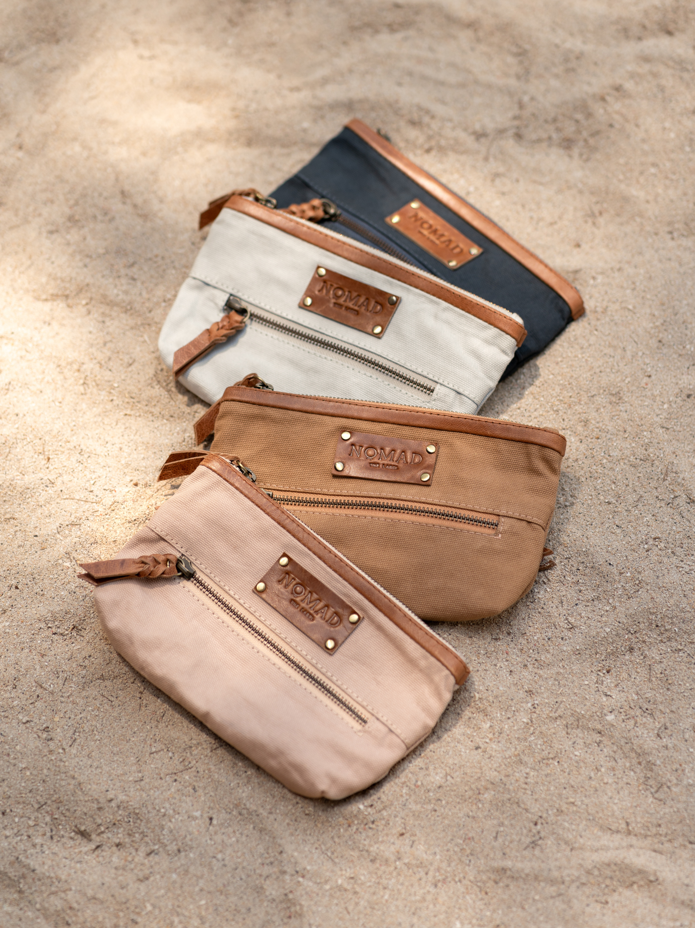 Image features Avalon Canvas Clutch in Tea Rose, Charcoal, Desert Sand & Slate Blue.