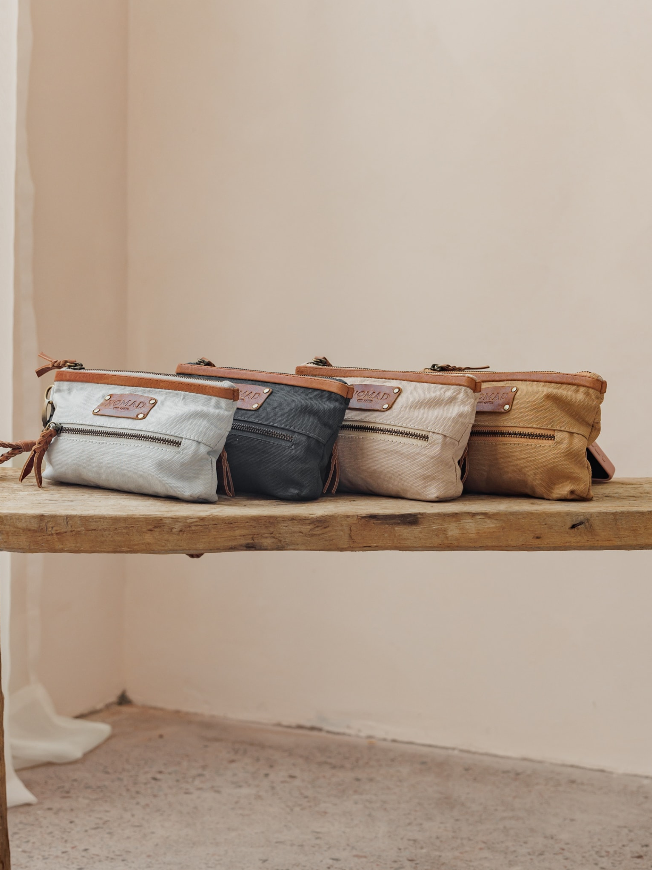 Image features Avalon Canvas Clutch in Tea Rose, Charcoal, Desert Sand & Slate Blue.