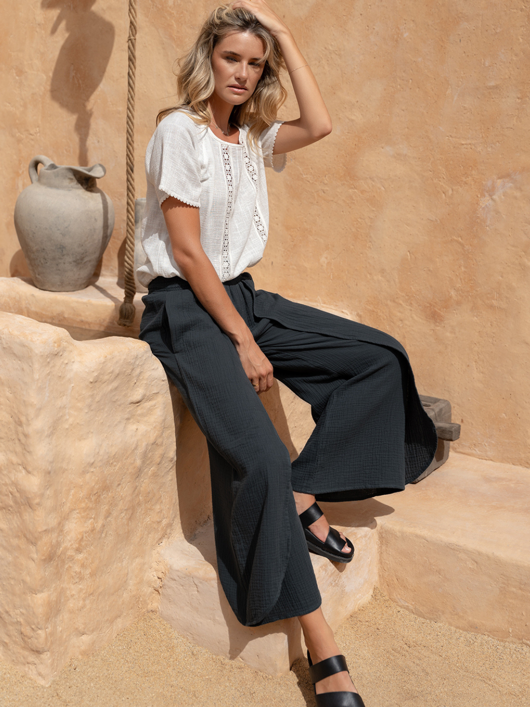 Model wears Asana Cotton Wrap Pants in Charcoal