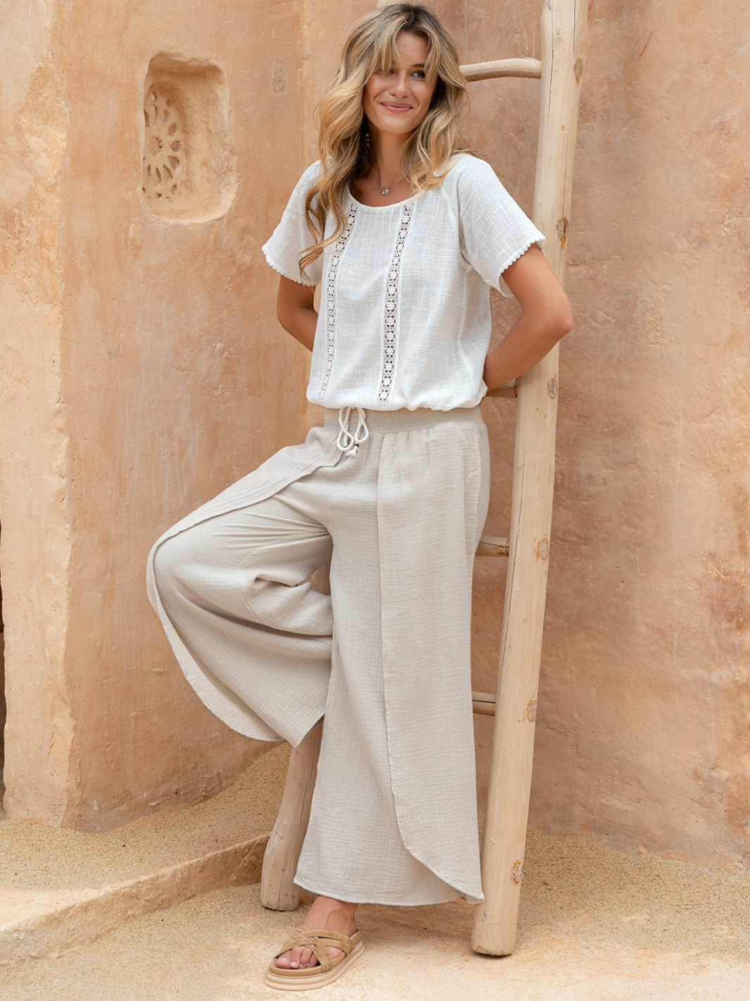 Model wears Asana Cotton Wrap Pants in Stone