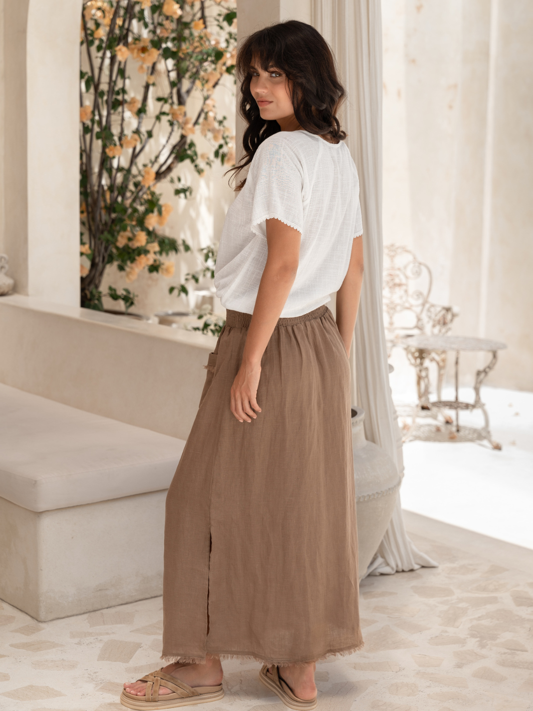 Model wears Aurora French Linen Skirt in Cinnamon