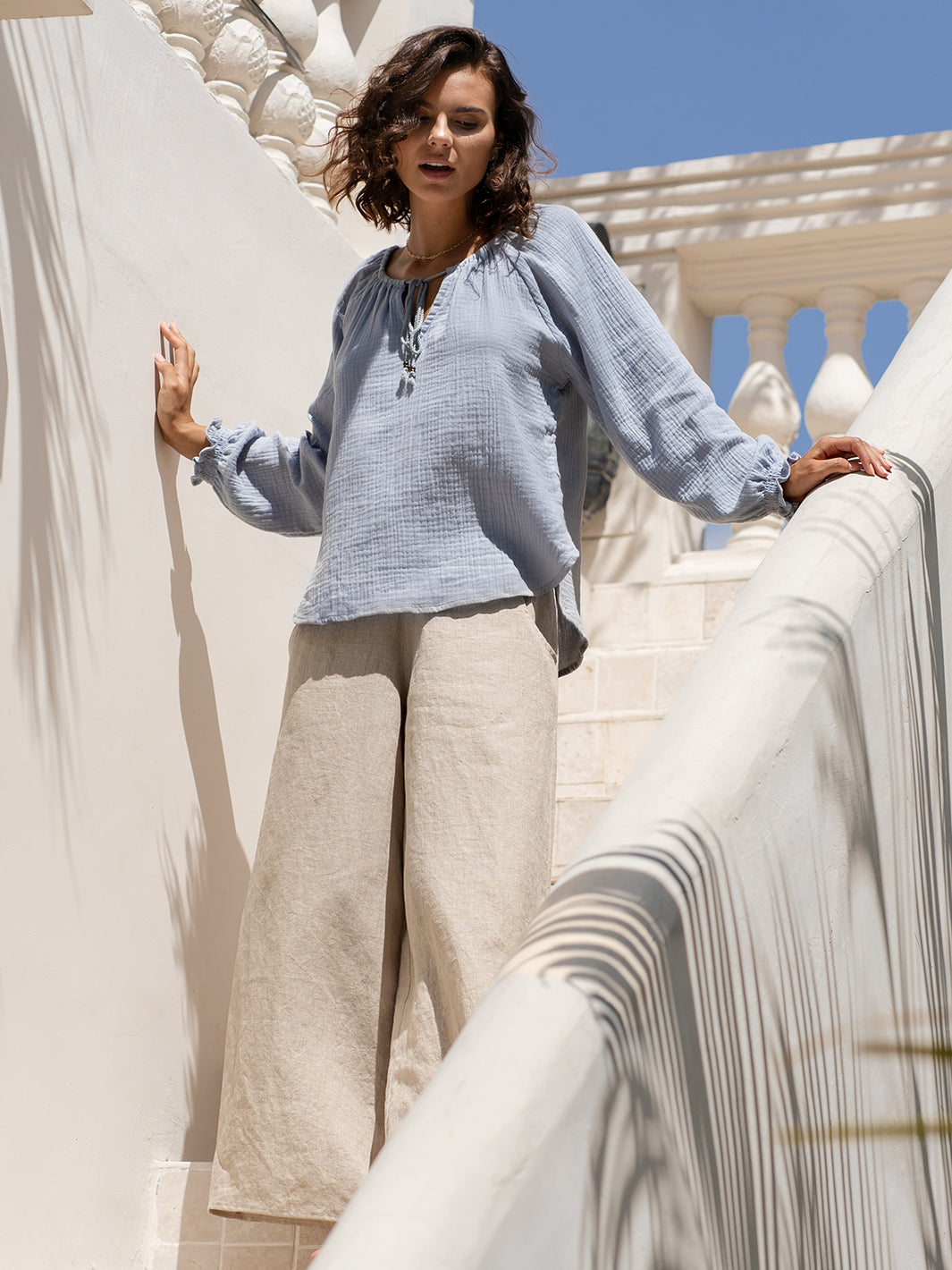 Model wears Capri Cotton Blouse in Slate Blue