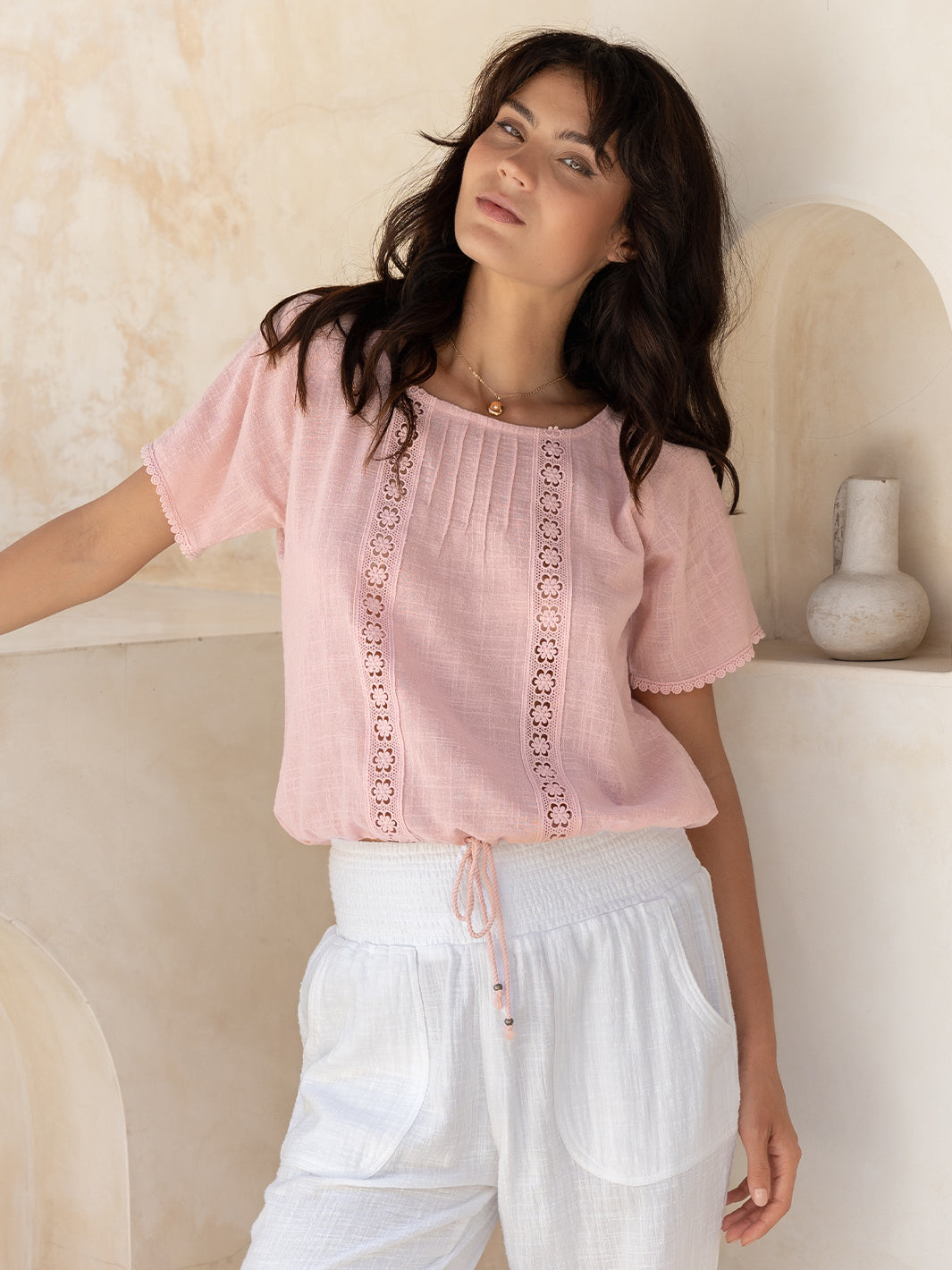 Model wears Daisy Organic Cotton Blouse in Dusty Pink.