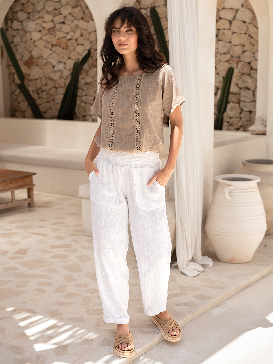 Model wears Delphi Cotton Pants in Ivory