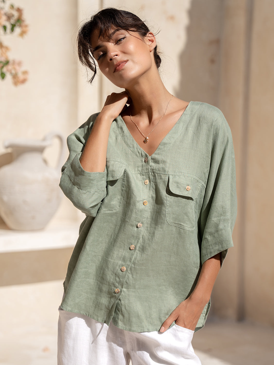 Model wears Dune French Linen Shirt in Moss