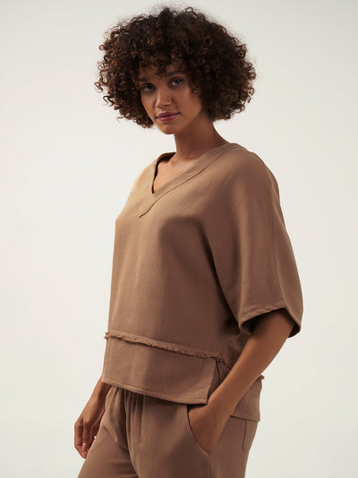 Model wears Floris Ramie Top in Desert Sand