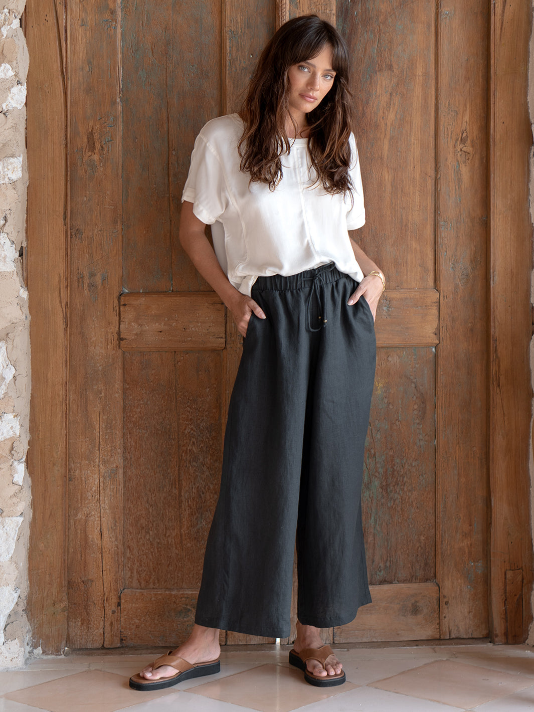 Model is wearing Gaia Linen Pants in Charcoal