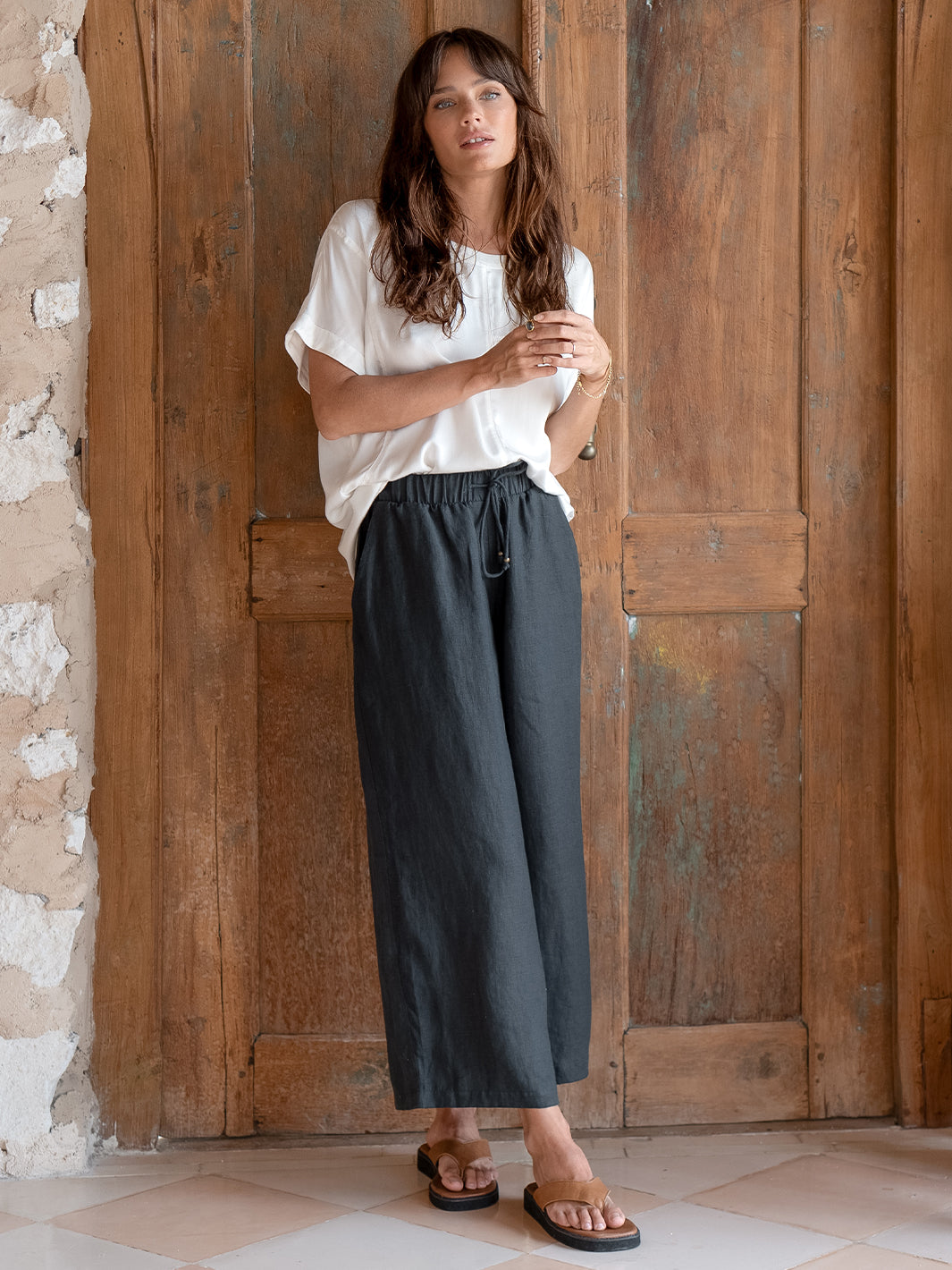 Model is wearing Gaia Linen Pants in Charcoal