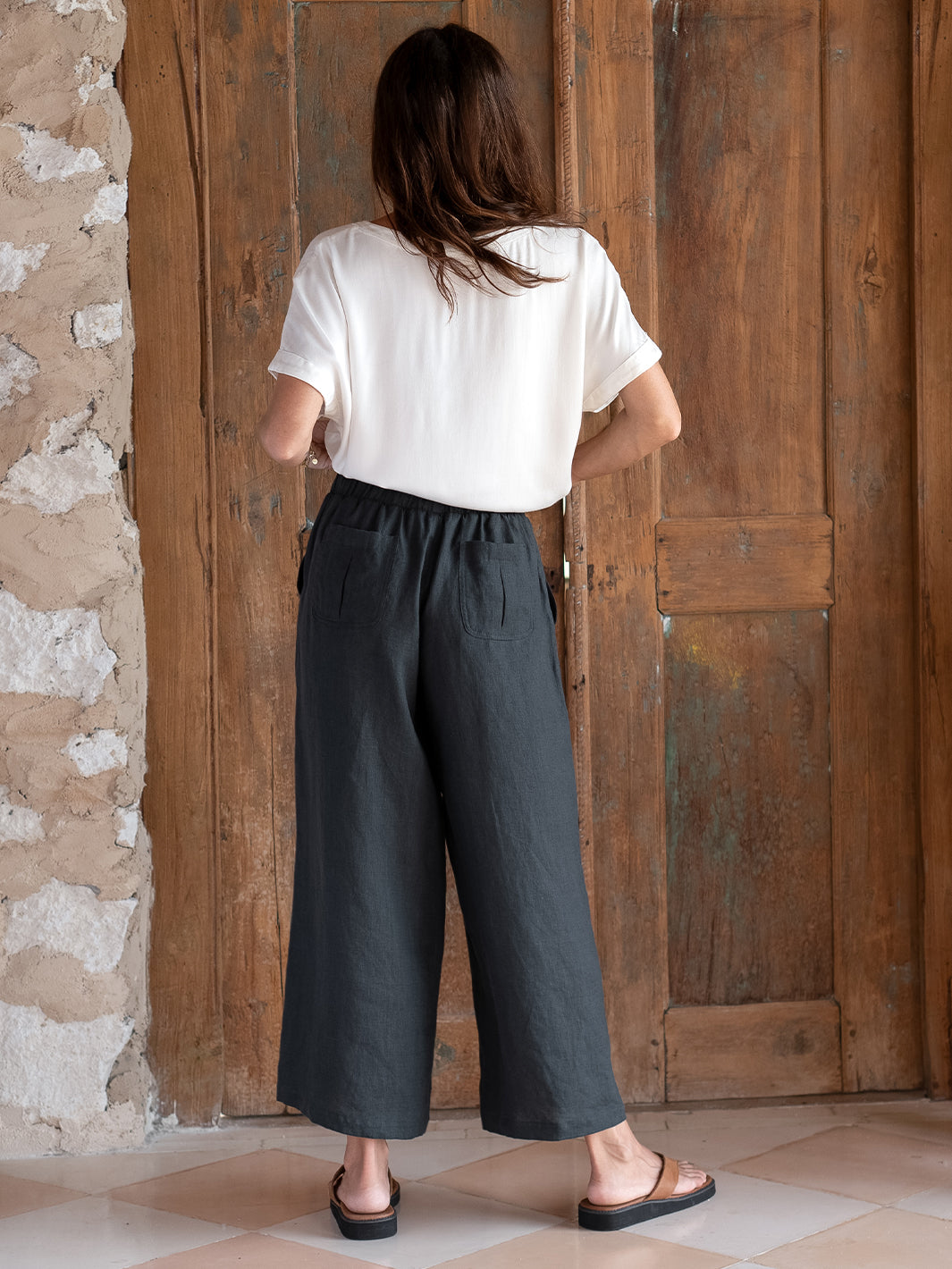 Model is wearing Gaia Linen Pants in Charcoal