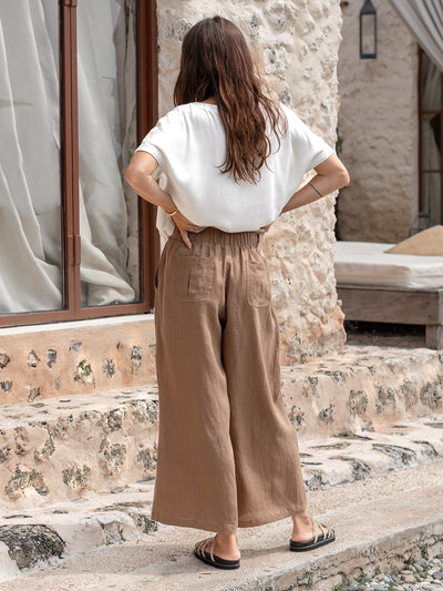 Model is wearing Gaia Linen Pants in Desert Sand