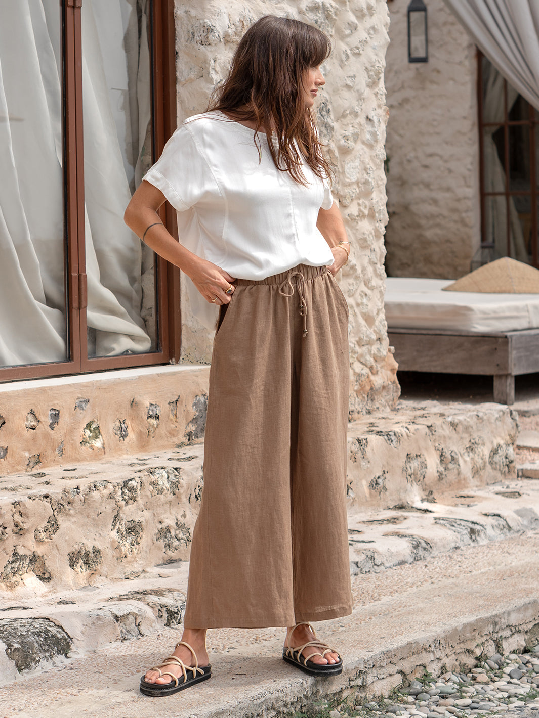 Model is wearing Gaia Linen Pants in Desert Sand