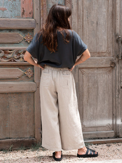 Model is wearing Gaia Linen Pants in Flax