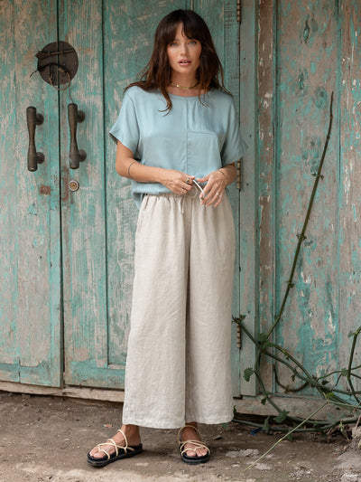 Model is wearing Gaia Linen Pants in Flax