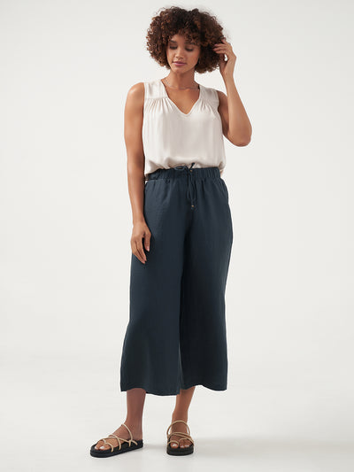 Model is wearing Gaia Linen Pants in Charcoal