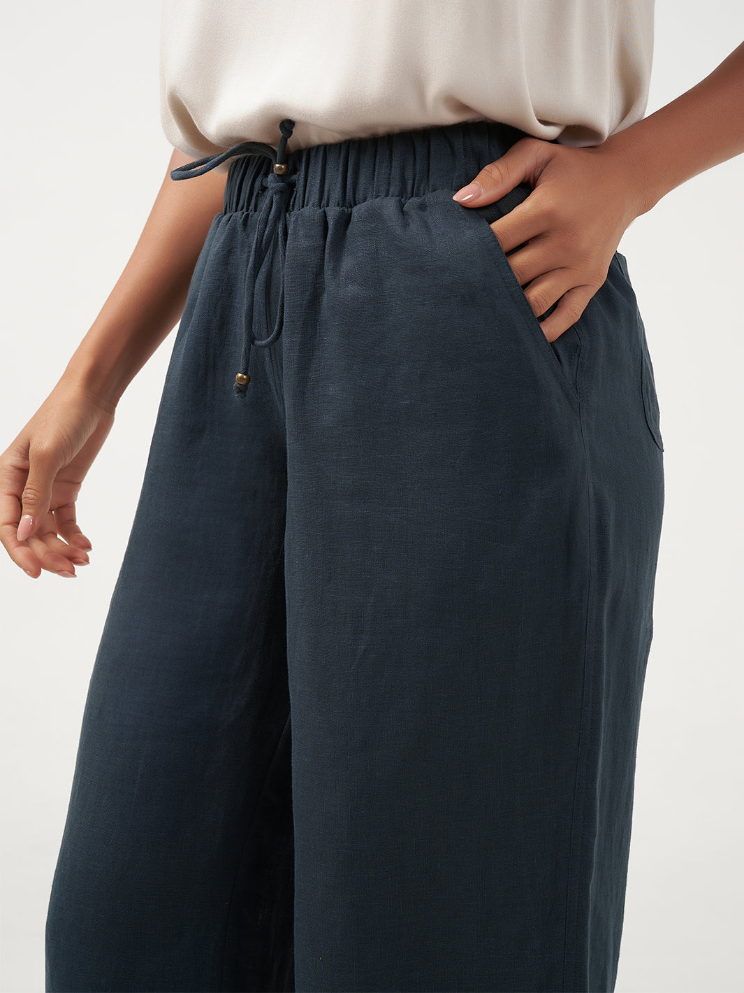 Model is wearing Gaia Linen Pants in Charcoal