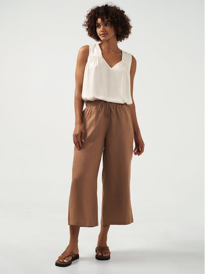 Model is wearing Gaia Linen Pants in Desert Sand