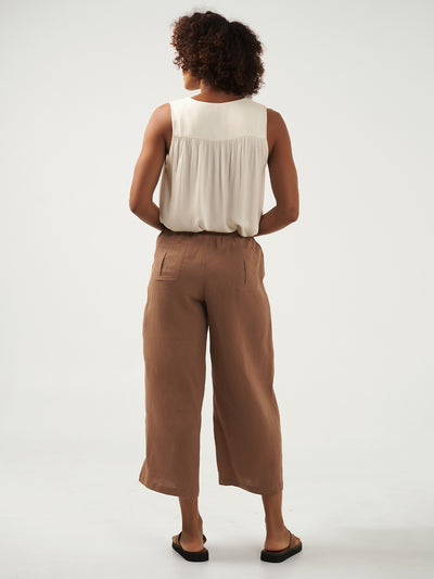 Model is wearing Gaia Linen Pants in Desert Sand