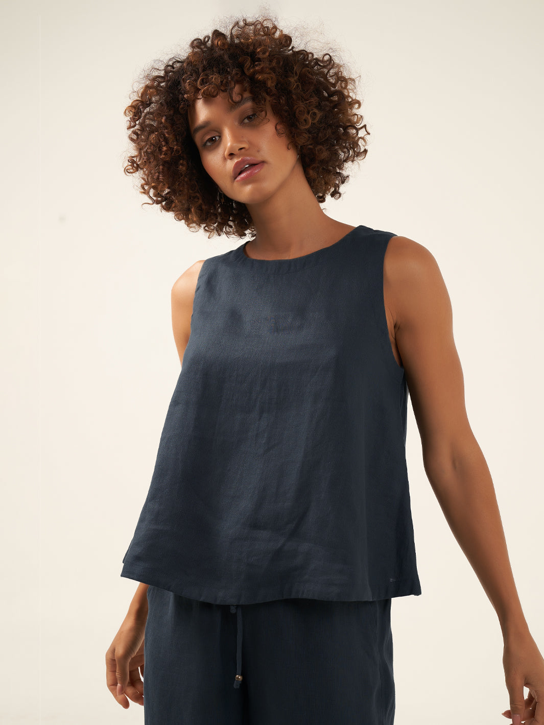 Model is wearing Lucia Linen Top in Charcoal.