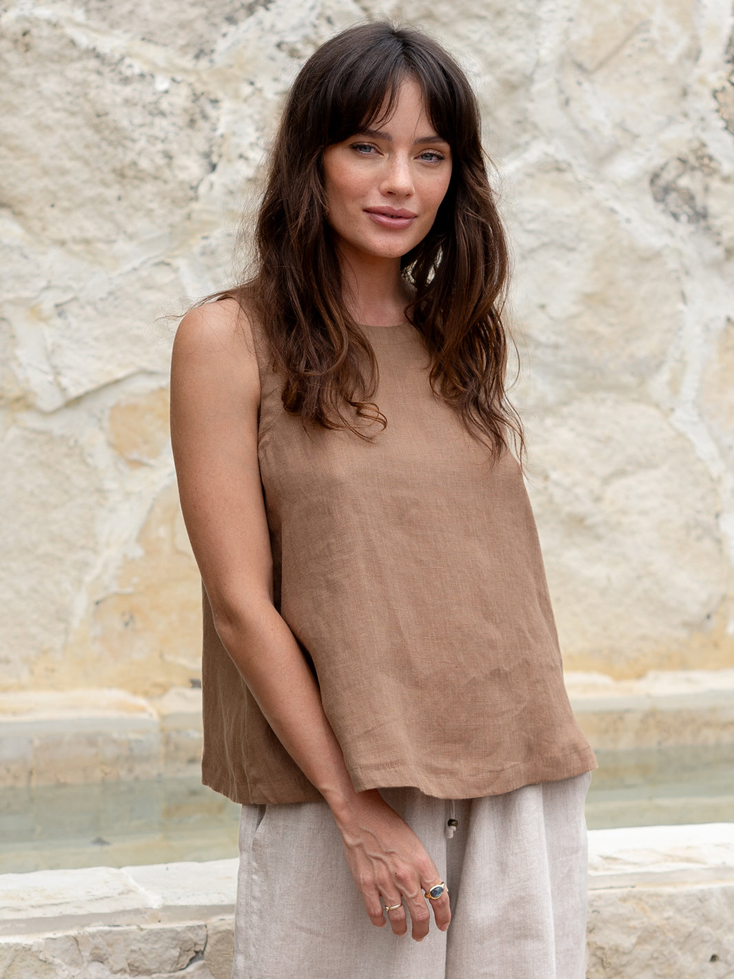 Model is wearing Lucia Linen Top in Desert Sand