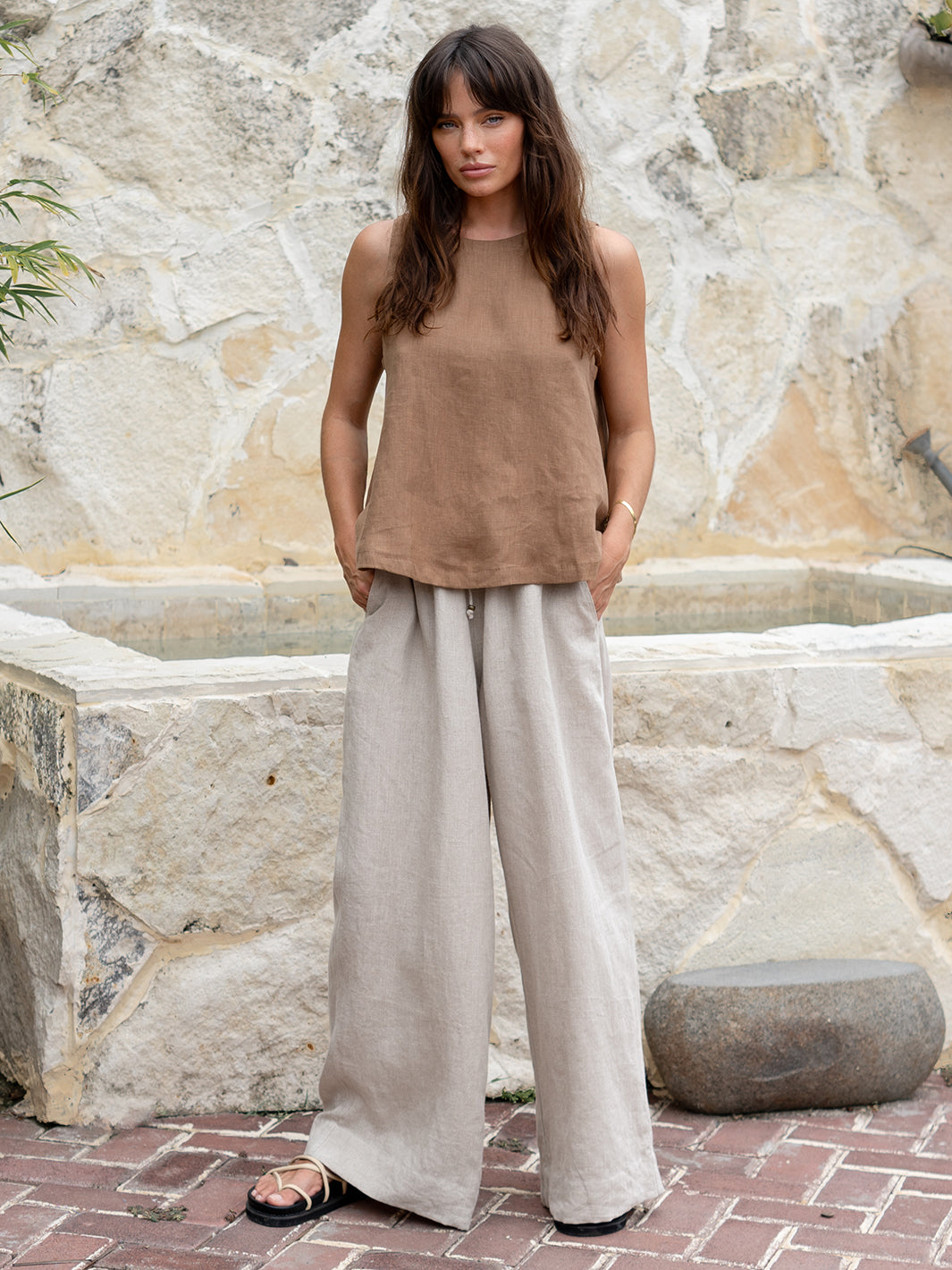 Model is wearing Lucia Linen Top in Desert Sand