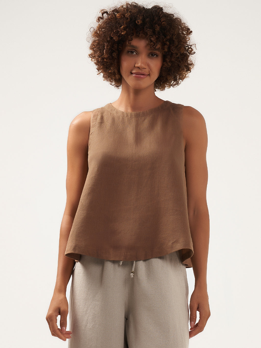 Model is wearing Lucia Linen Top in Desert Sand.