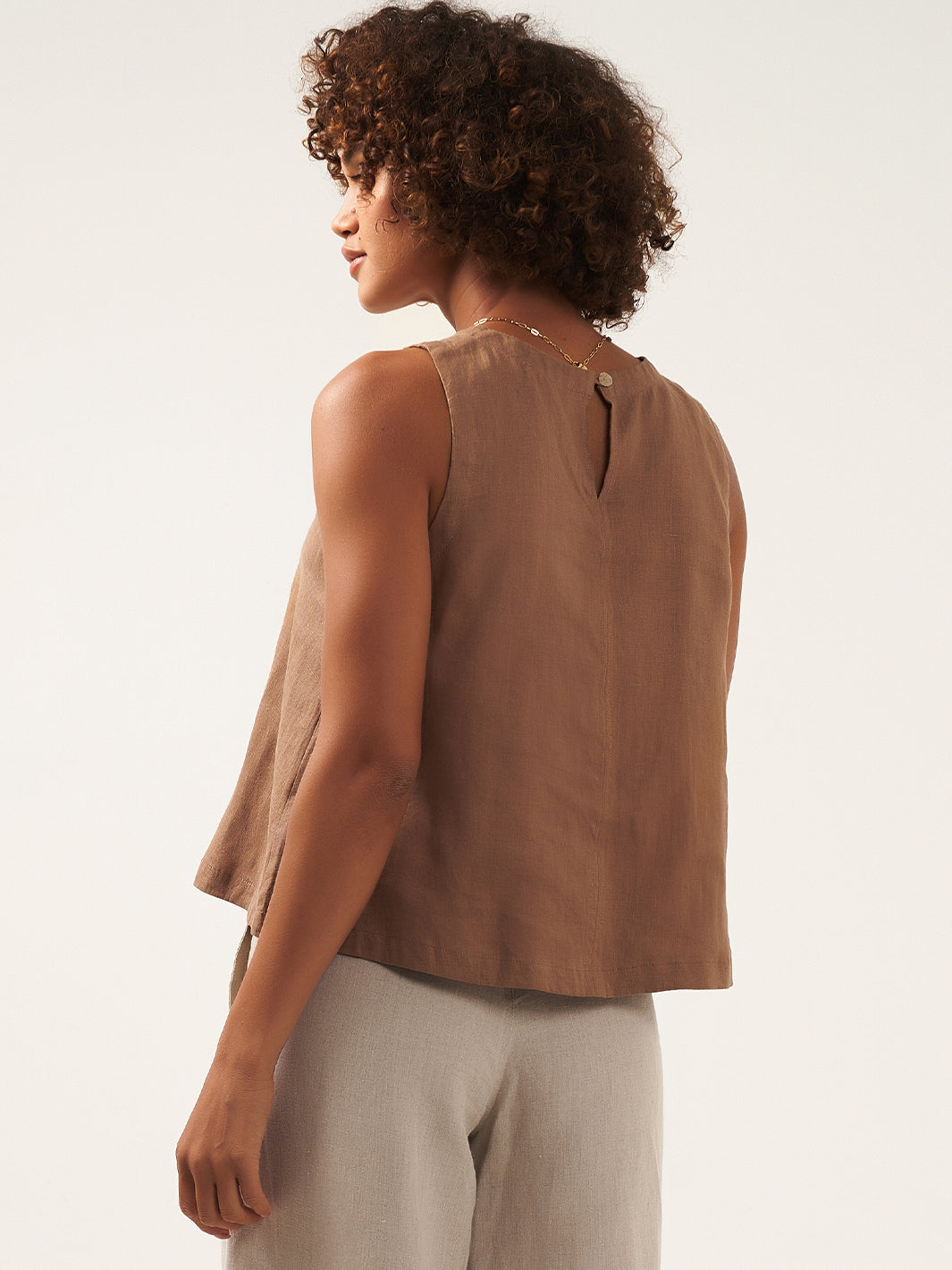 Model is wearing Lucia Linen Top in Desert Sand.