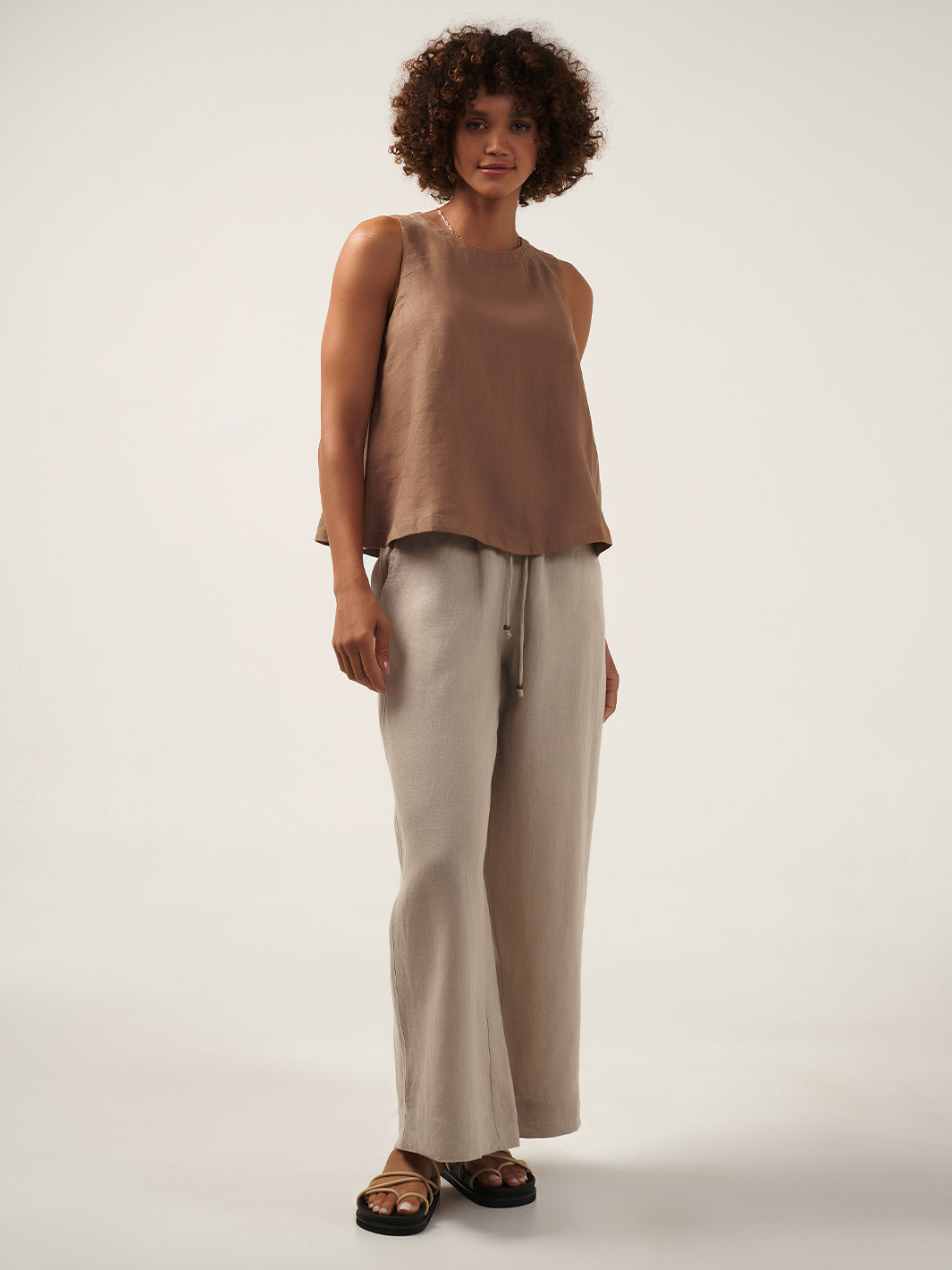 Model is wearing Lucia Linen Top in Desert Sand.