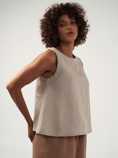 Model is wearing Lucia Linen Top in Flax.