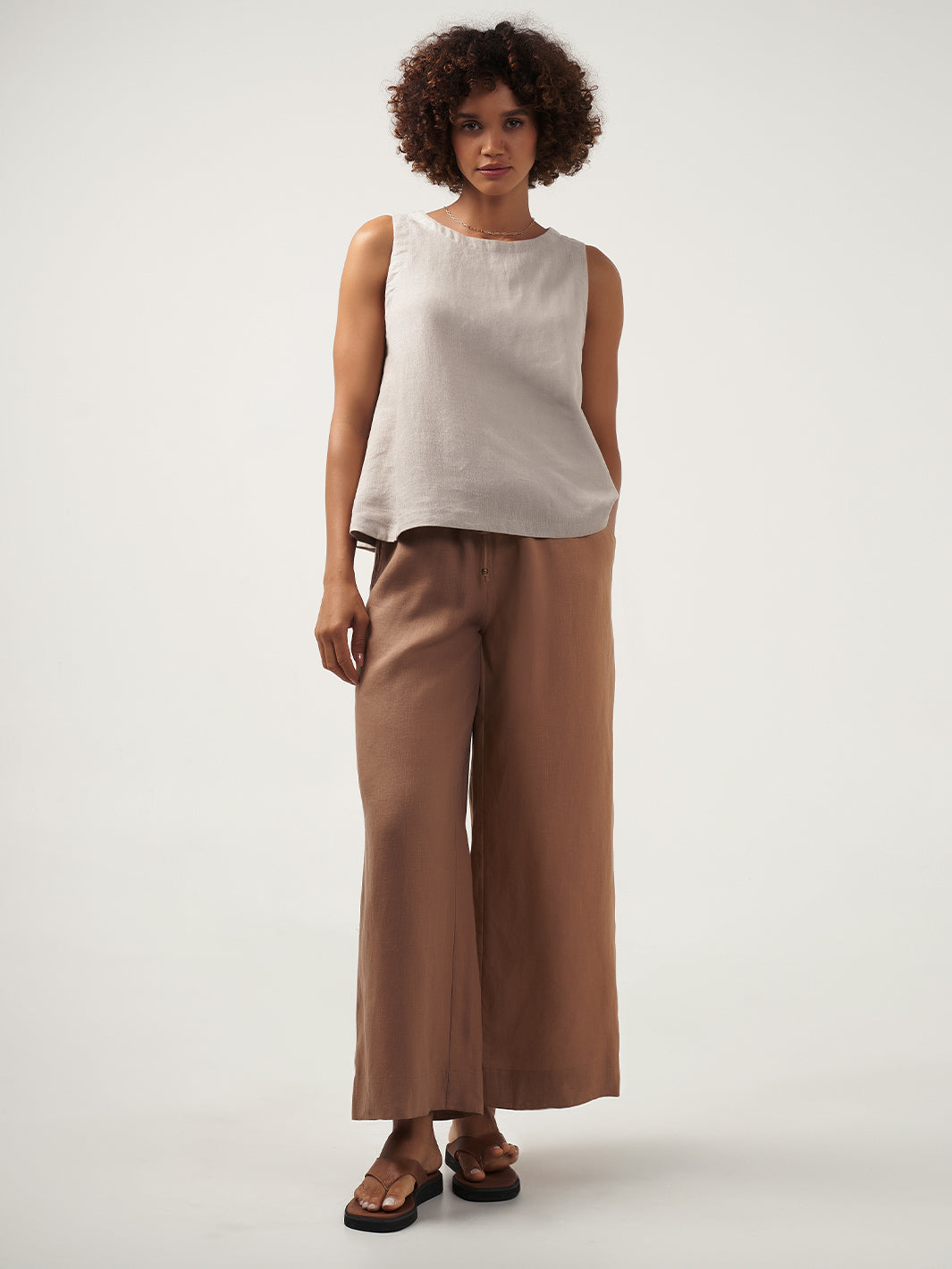 Model is wearing Lucia Linen Top in Flax.