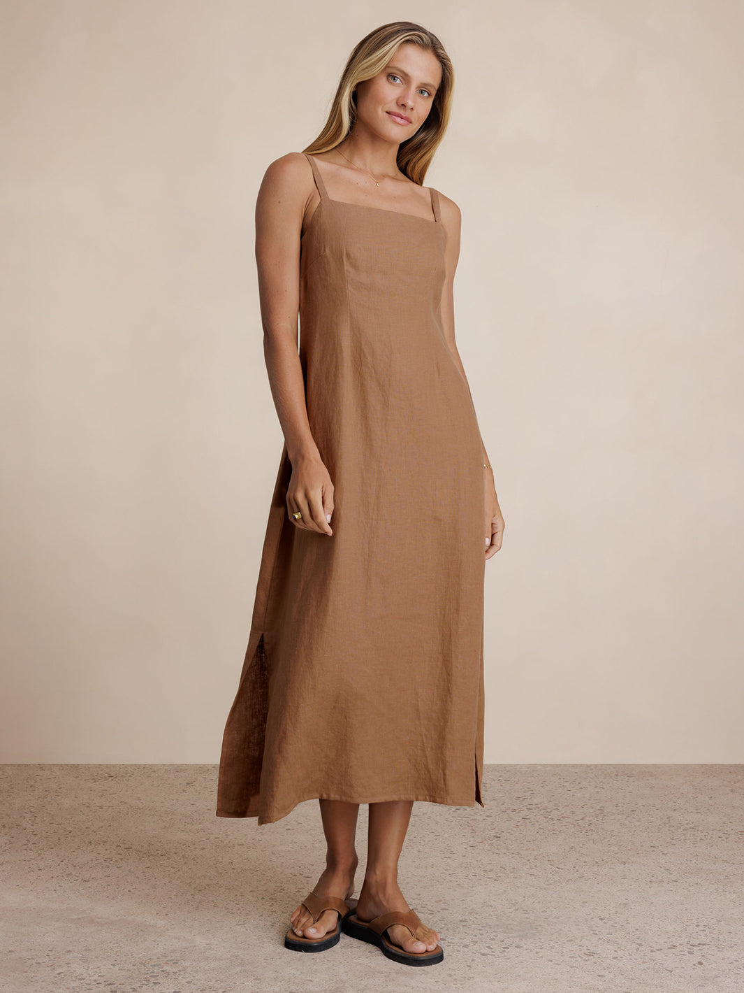 Model wears Mahlia Linen Midi Dress in Desert Sand