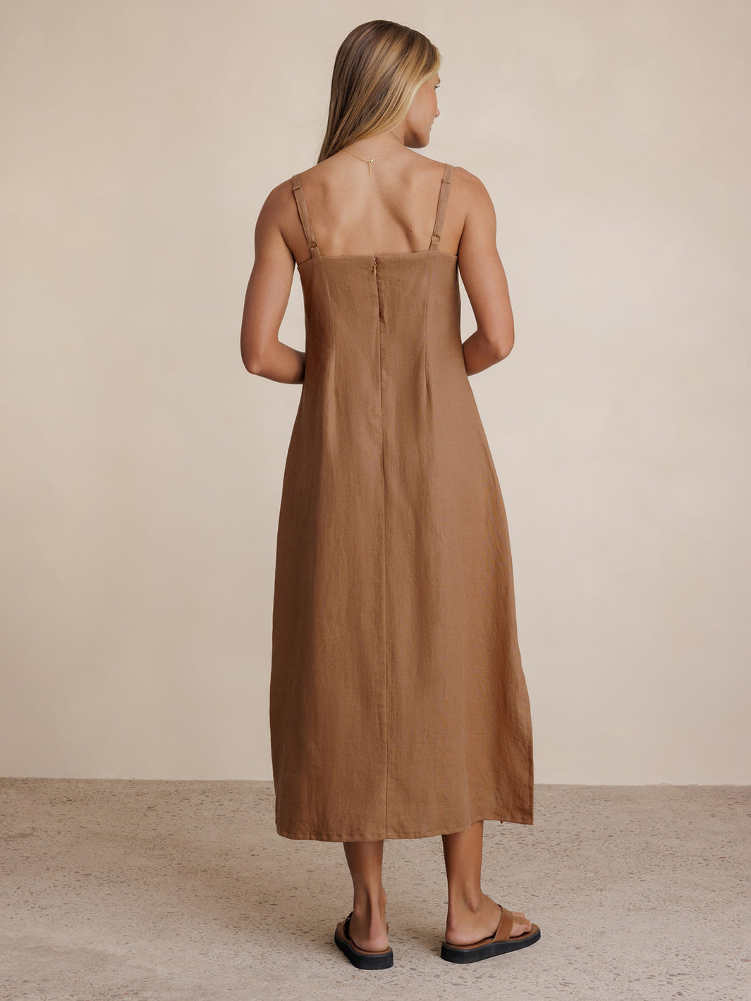 Model wears Mahlia Linen Midi Dress in Desert Sand