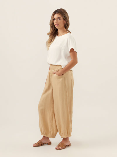 Model wears Sadhu French Linen Pants in Sand