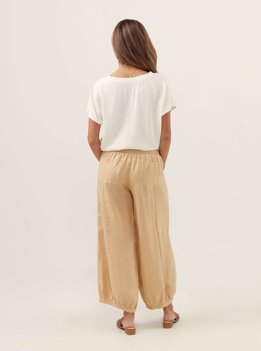 Model wears Sadhu French Linen Pants in Sand