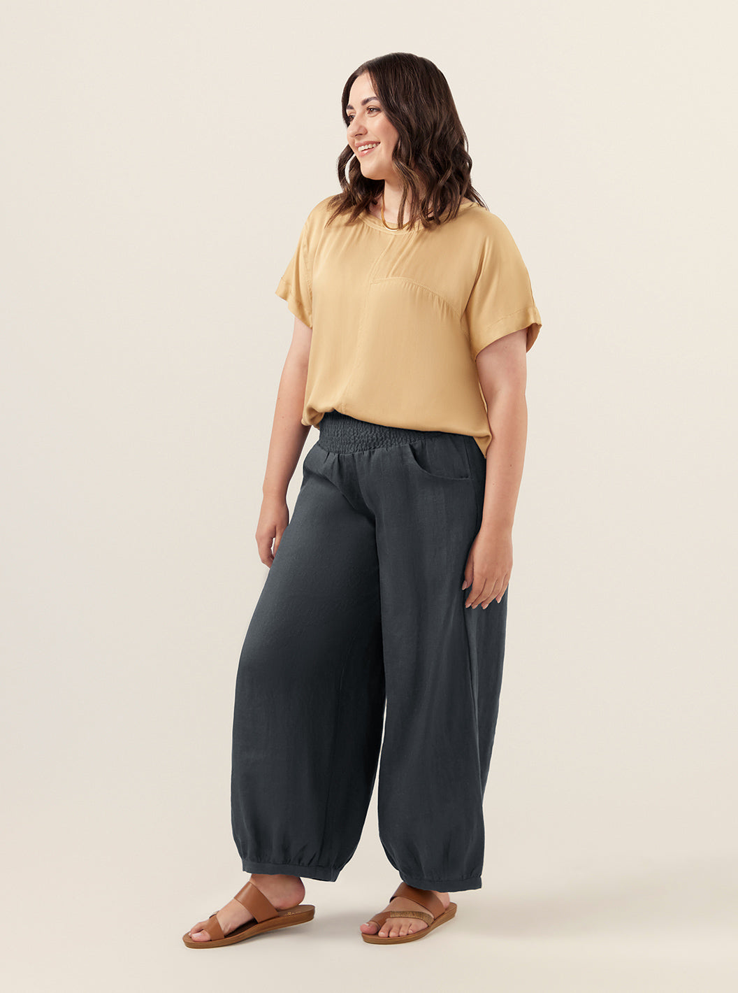 Model wears Sadhu French Linen Pants Regular in Charcoal.