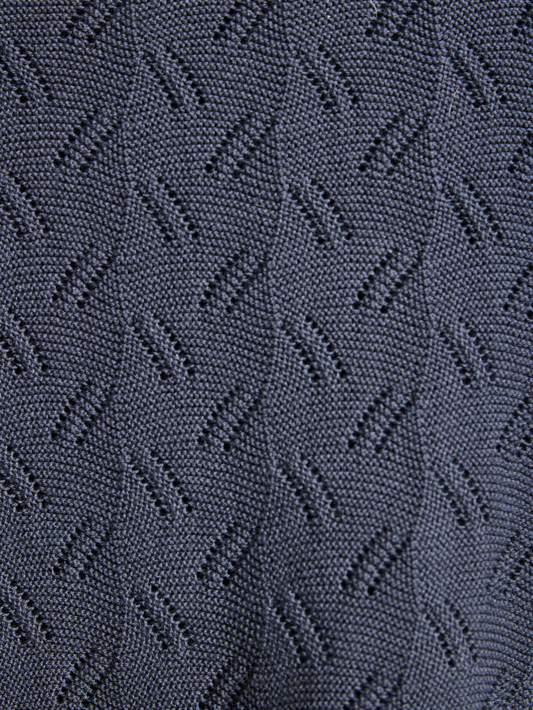 Close-up of textured dark fabric with geometric pattern