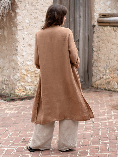 Model is wearing Nova Longline Linen Coat in Desert Sand