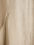 Close-up of beige linen fabric with a pocket detail