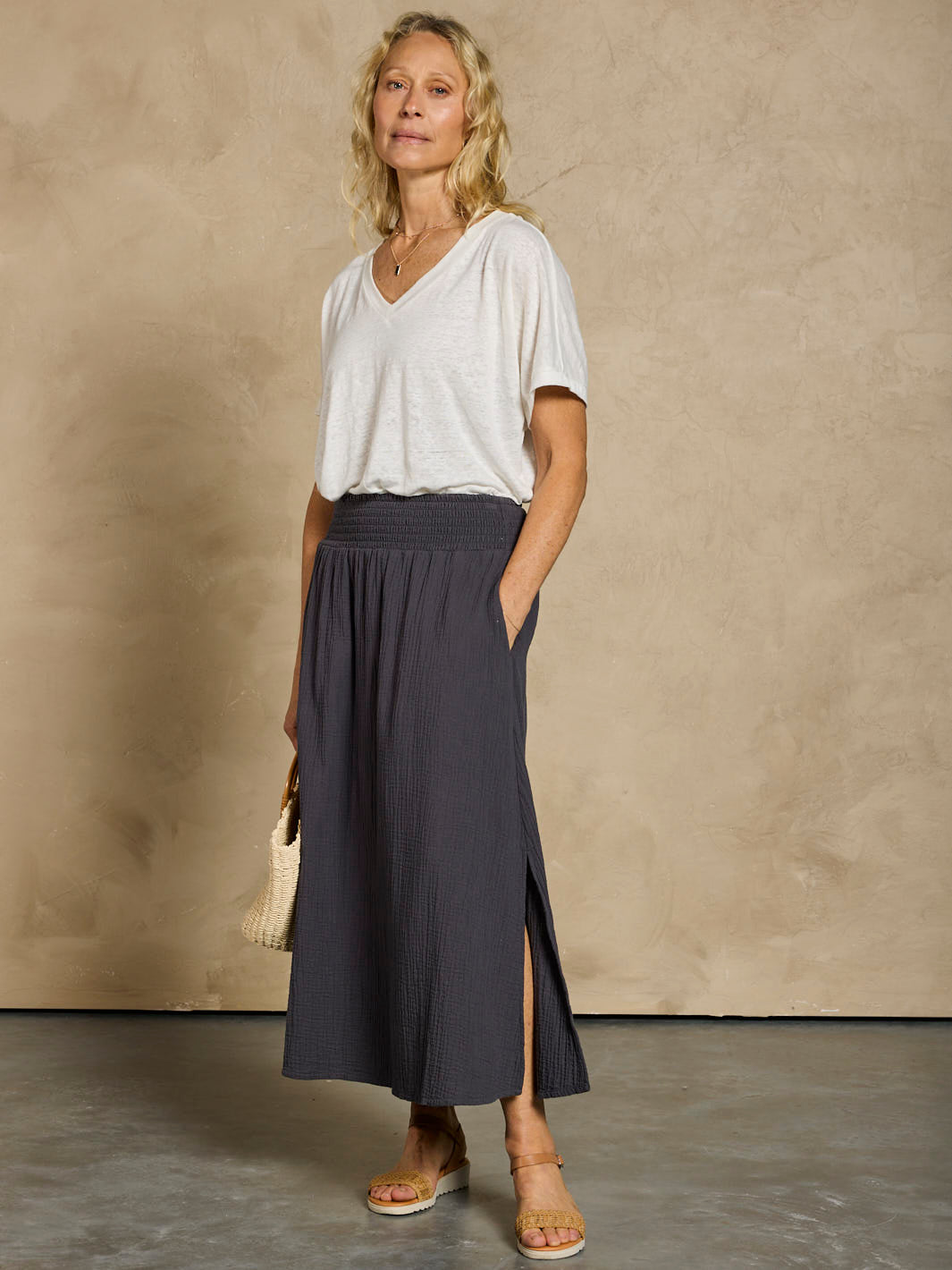 Woman in a white linen top and black cotton skirt 