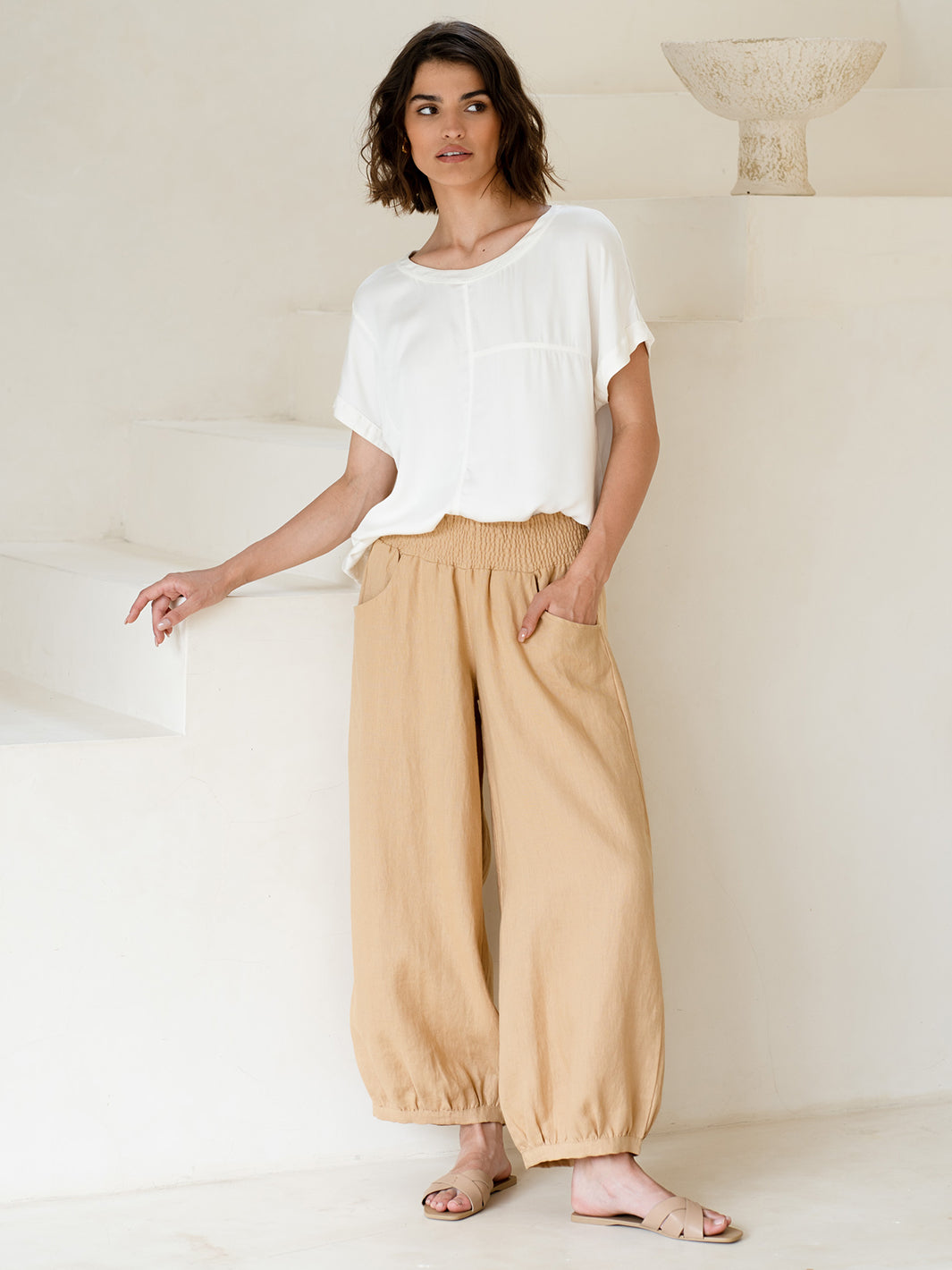 Model wears Sadhu French Linen Pants in Sand