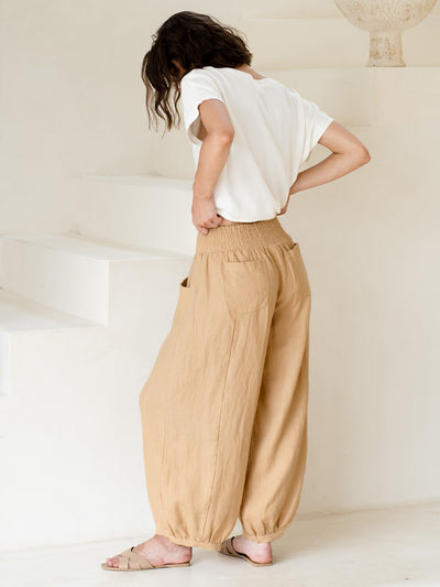 Model wears Sadhu French Linen Pants in Sand